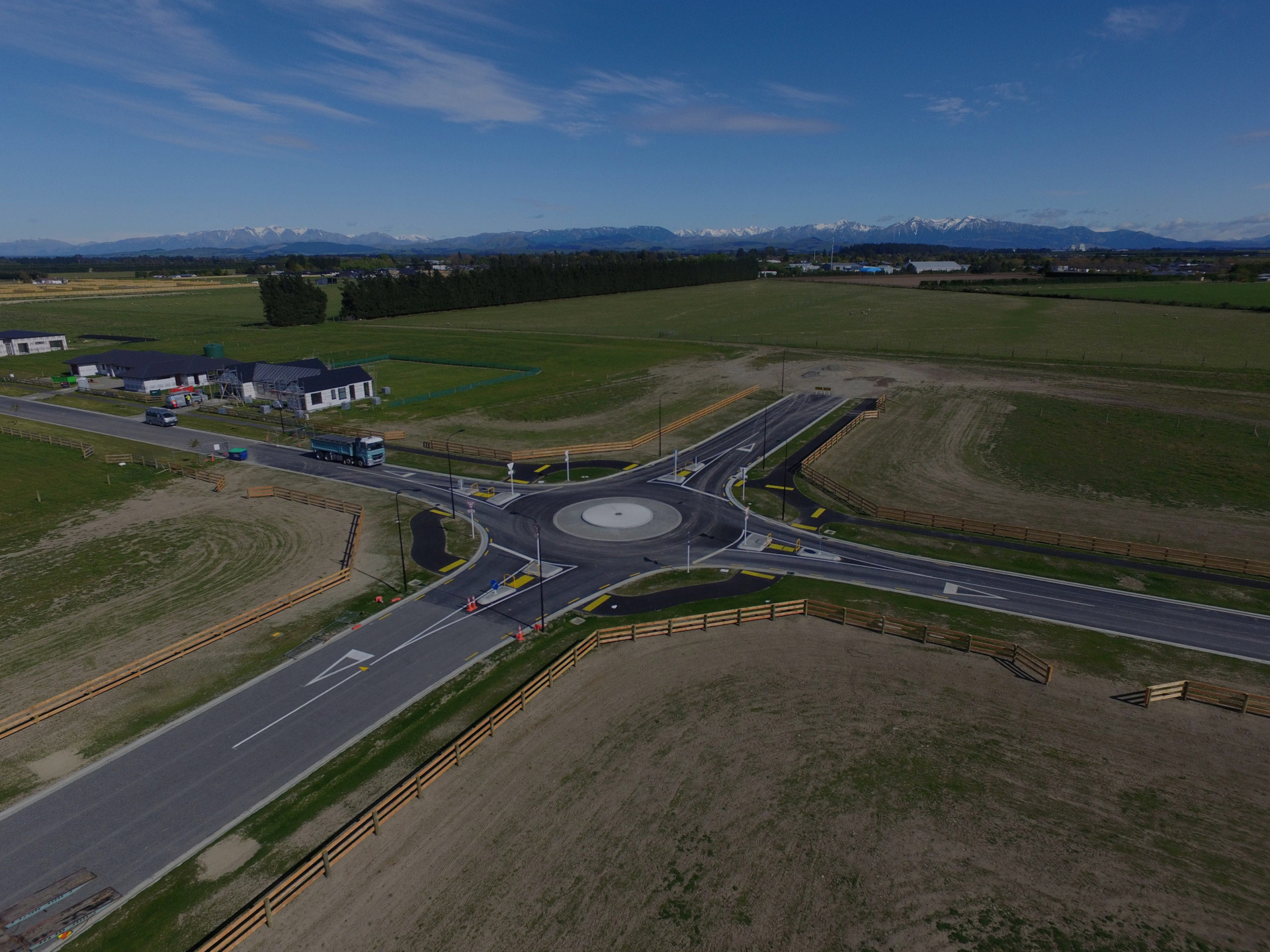 Aerial view of the completed traffic circle in Darfield subdivision, Selwyn District, built by EDR Contracting, showing new residential homes and connecting paved roads.