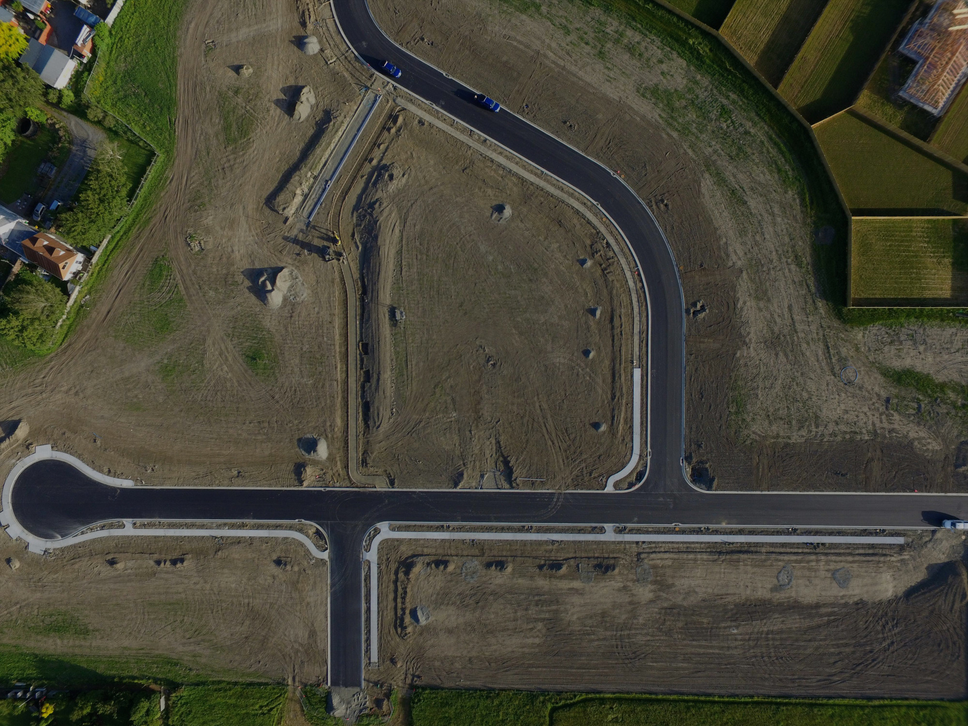 Top-down aerial image of a Christchurch subdivision development by EDR Contracting, showing paved roads, installed utilities, and precisely finished groundworks awaiting fencing and grass seeding for final completion.
