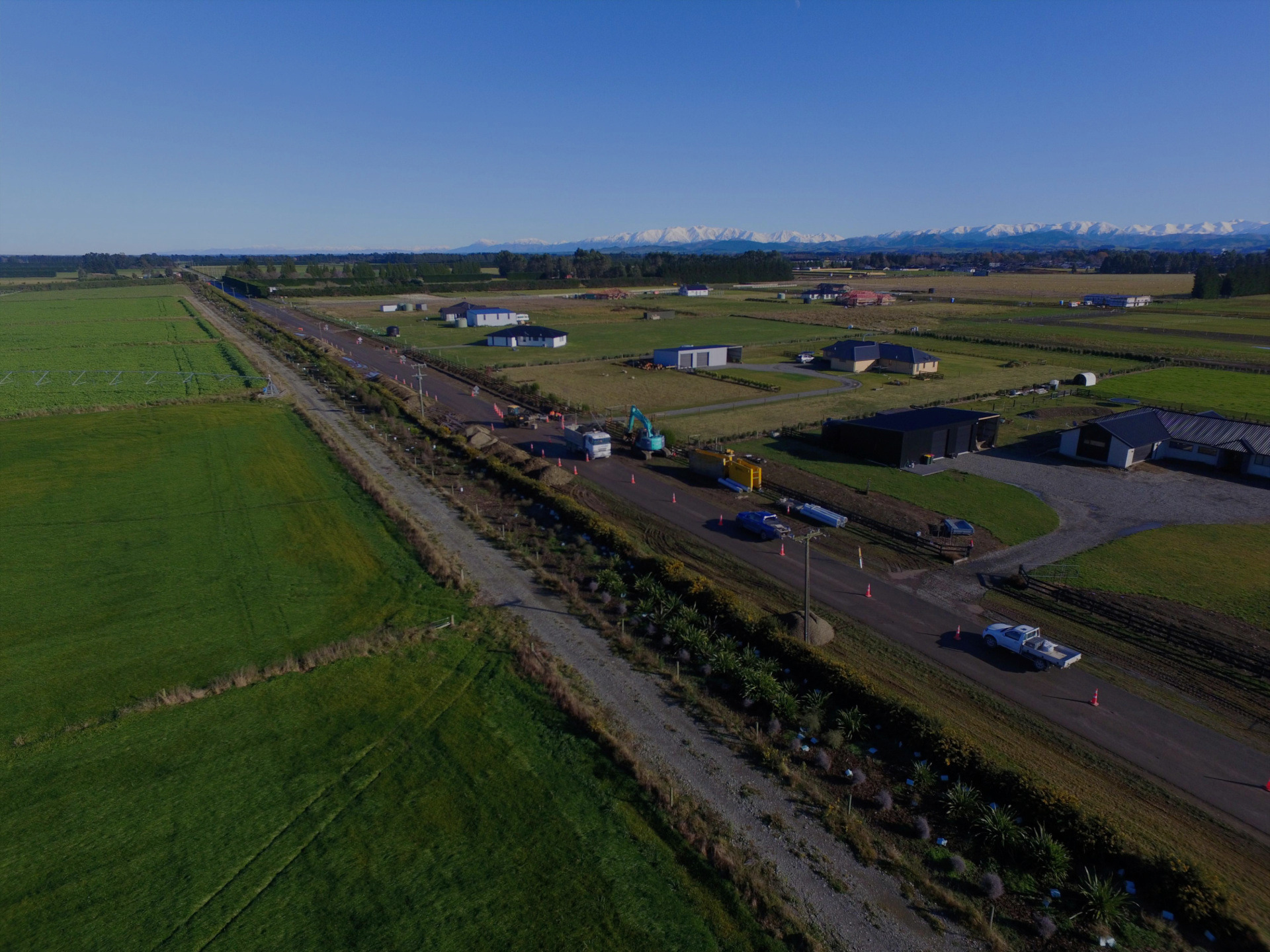 Aerial view of EDR Contracting improving road drainage and infrastructure near Darfield, Canterbury, with the Southern Alps rising behind the development site.